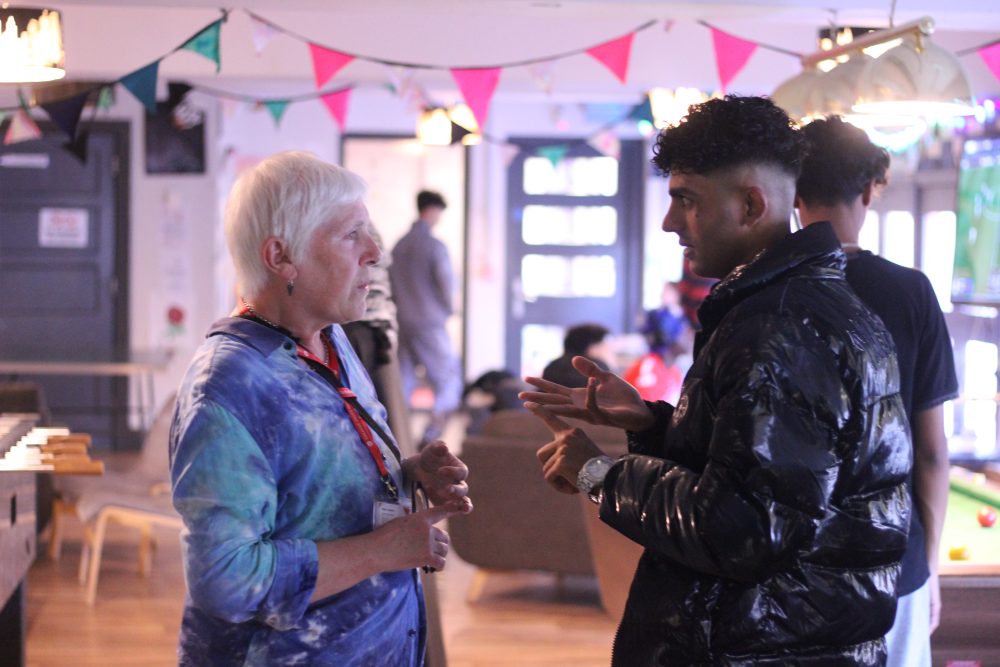 Youth worker and young person talking in chill out space