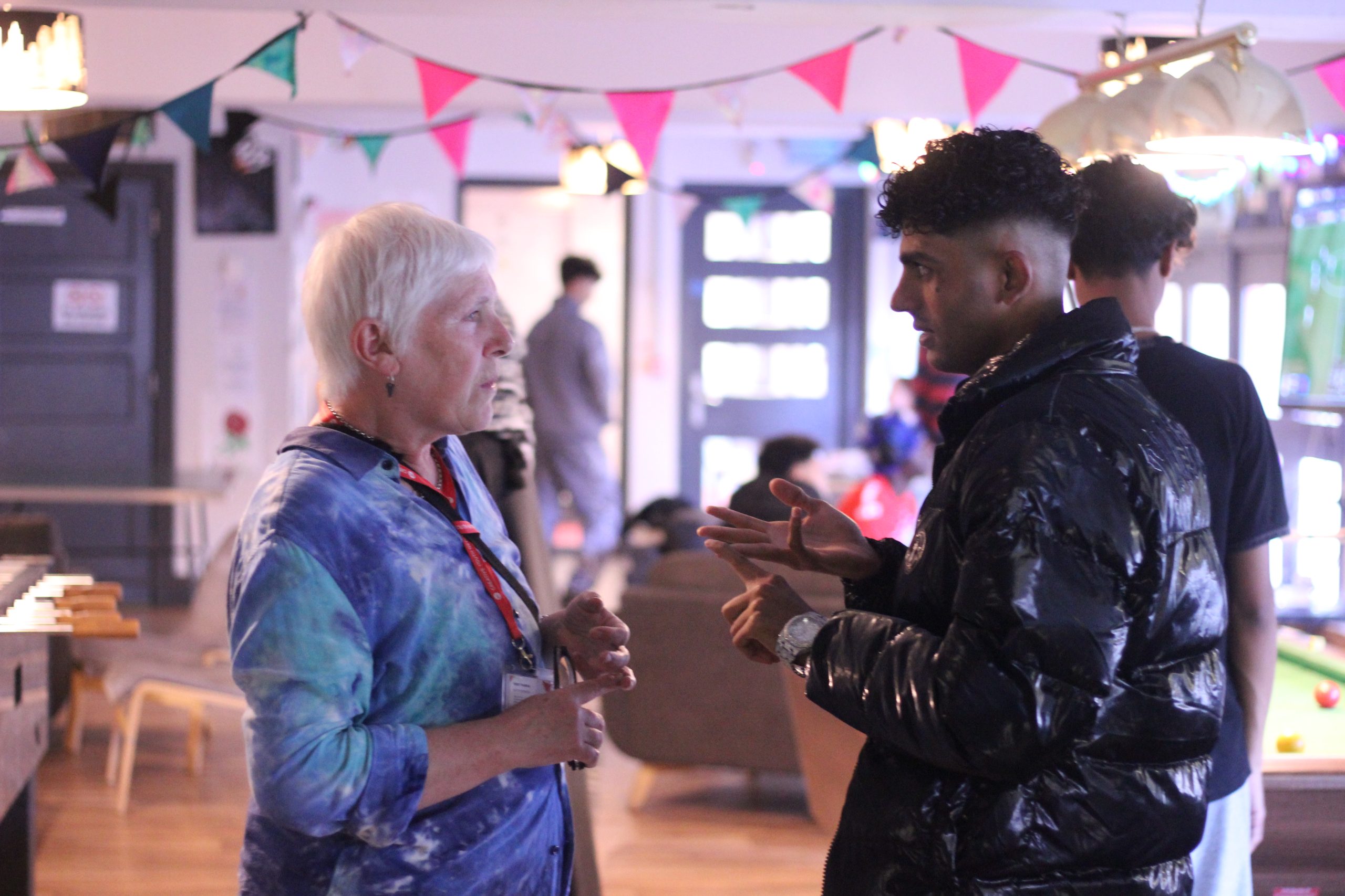 Youth worker and young person talking in chill out space